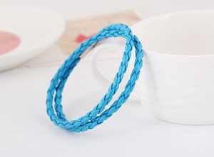 Detail of bright blue woven leather bracelet with silver magnetic metal clasp in double wrap