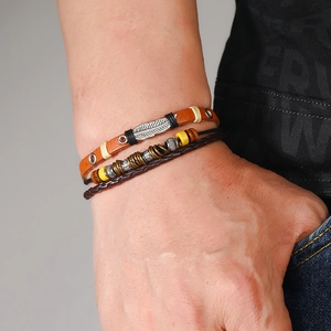 Multilayer leather bracelet with feather pendant and beaded cords for men in retro style
