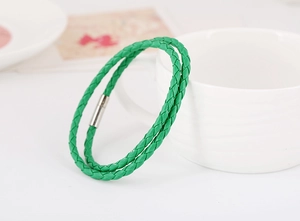 Close-up of green woven leather double wrap bracelet with silver magnetic clasp