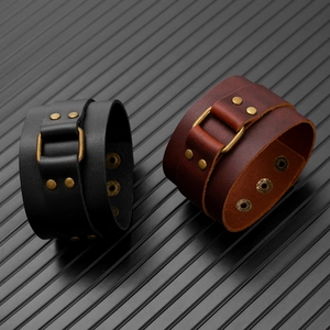 Detail of adjustable leather bracelets featuring bronze studs and snap fasteners