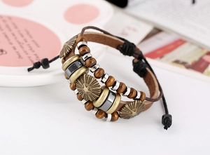 Detail of vintage beaded leather bracelet featuring bronze star charms and wood beads