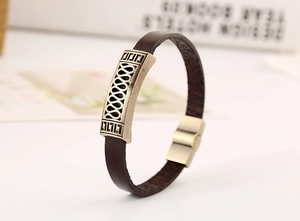 Detail of vintage brown leather bracelet with bronze infinity symbol and magnetic clasp