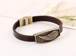 Detail of vintage wing ornament on dark brown leather bracelet with bronze magnetic clasp