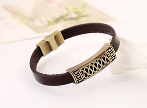 Macro shot of men's leather bracelet with antique gold metal magnetic clasp and geometric pattern