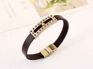 Detail of dark brown leather bracelet with bronze alloy cross star magnetic clasp