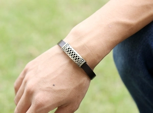 Macro shot of men's leather bracelet with vintage bronze pattern and geometric metal buckle