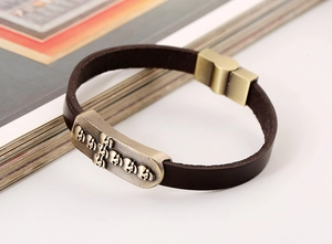 Detail of vintage punk leather bracelet featuring skull relief and magnetic buckle