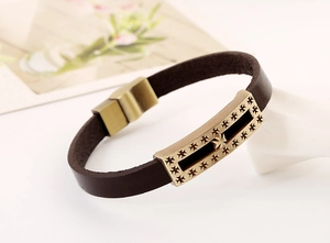 Macro view of vintage bronze metal plate and brown leather texture on gothic bracelet
