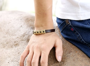 Detail of vintage moon and star镂空 alloy plate on dark brown genuine leather bracelet