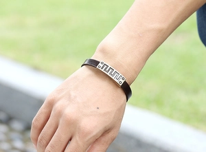 Detail of retro leather bracelet with rectangular geometric pattern metal plate