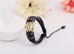 Detailed close-up of Libra zodiac leather bracelet with braided ropes and bronze charm