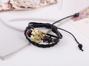 Detail of Libra zodiac leather bracelet with braided cords, wood beads and metal charm