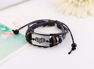 Macro view of multi-layer leather bracelet with antique silver LOVE metal plate