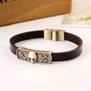 Vintage men's brown leather bracelet featuring a bronze skull metal plate and magnetic clasp