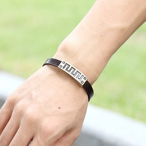Retro dark brown leather bracelet with geometric metal plate shown on a model wrist