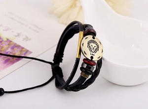 Macro shot of Leo zodiac leather bracelet with antique bronze charm and wooden beads