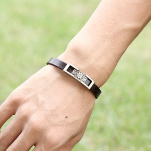 Vintage men's leather bracelet with antique bronze metal sunburst pattern plate