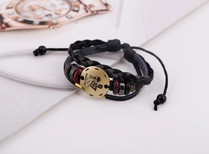 Close-up of handmade Aquarius constellation leather bracelet with beads and vintage charm