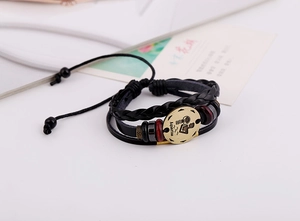 Close-up of handmade Aquarius leather bracelet with bronze zodiac charm and beads
