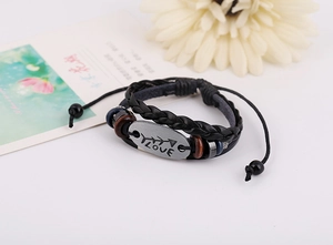 Detail of multi-layer leather bracelet with vintage LOVE metal plate and arrow charm