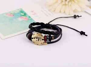 Macro shot of Virgo zodiac leather bracelet with antique brass charm and woven cord