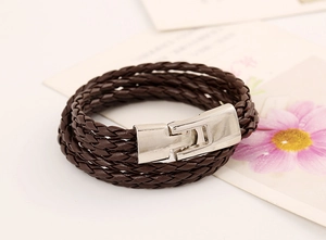 Close-up of brown multi-layer braided leather bracelet with a silver metal clasp