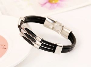 Close-up of a multi-layer black leather bracelet featuring silver curved metal accents