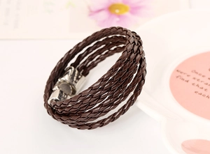 Close-up of five-layer brown woven leather bracelet with polished silver magnetic clasp