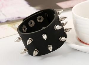 Close-up of punk leather bracelet with silver metal spikes and adjustable snap buttons