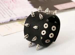 Detail of punk leather bracelet with silver metal spikes and adjustable snap buttons