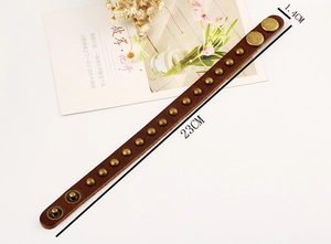 Detail of dark brown leather bracelet with 15 brass studs, length 23cm, width 1.4cm