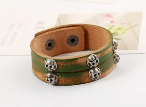 Detail of vintage double-layer leather bracelet with silver skull rivets and snap button