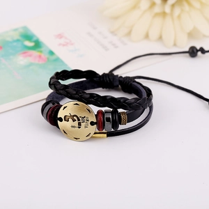 Handmade leather multi-layer Virgo zodiac beaded bracelet with bronze charm on white desk