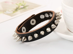 Detail of punk leather bracelet with silver metal spikes and double snap buttons