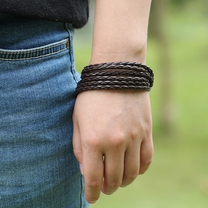 Classic double-layer braided dark brown leather bracelet shown on model in nature