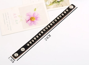 Detail view of punk black leather rivet bracelet with dimensions 24cm by 1.5cm
