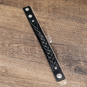 Detail view of multilayer braided leather bracelet with silver snap buttons, 23cm length
