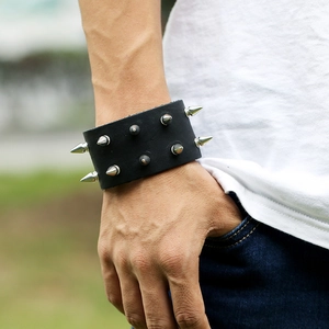 Punk style black leather wristband with double-row silver metal studs worn on wrist