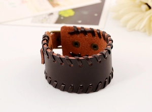 Macro detail of dark brown leather cuff with hand-stitched edges and metal rivet clasp