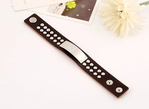 Detail of vintage punk leather bracelet with silver metal rivets and screw motifs