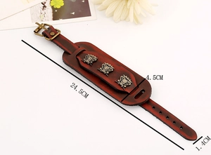 Detailed view of vintage double-layer leather bracelet with bronze badges and buckle