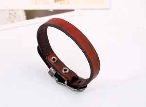 Macro detail of vintage punk reddish brown cowhide leather bracelet with metallic snap fasteners