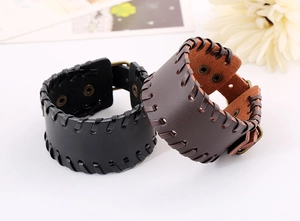 Detailed close-up of retro braided leather bracelets in black and brown with bronze buckles