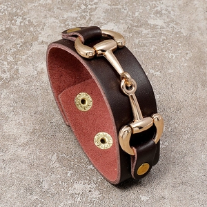 Minimalist wide brown leather bracelet with golden horsebit buckle and snap closure