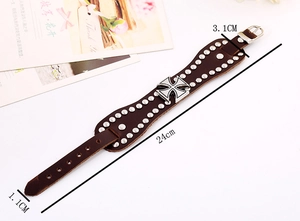 Macro view of vintage punk leather bracelet with cross emblem and silver rivets
