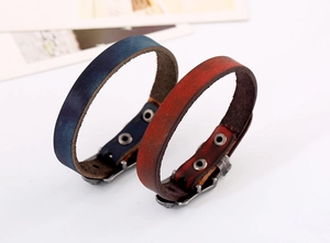 Detail of vintage gradient wide leather bracelets with metal snap button closures
