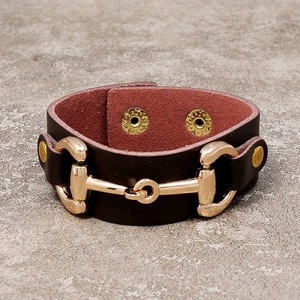 Vintage brown leather cuff bracelet with gold horsebit hardware and adjustable snaps