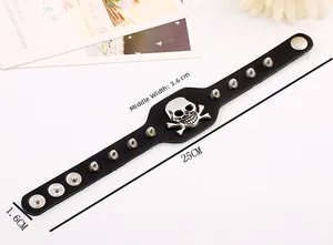 Detail view of punk leather bracelet with skull motif and metal studs including dimensions
