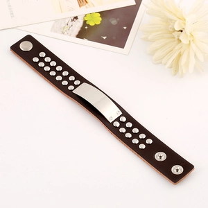 Vintage brown leather punk bracelet with silver studs and a polished metal plate
