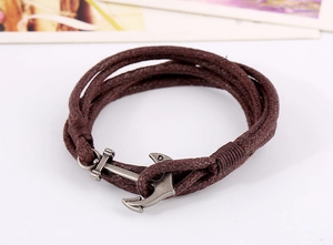 Close-up of dark brown multi-layer braided rope bracelet with vintage silver anchor clasp